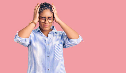 Young african american woman with braids wearing casual clothes and glasses suffering from headache desperate and stressed because pain and migraine. hands on head.