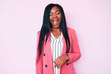 Young african american woman wearing business clothes winking looking at the camera with sexy...