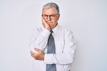 Senior grey-haired man wearing business clothes thinking looking tired and bored with depression problems with crossed arms.