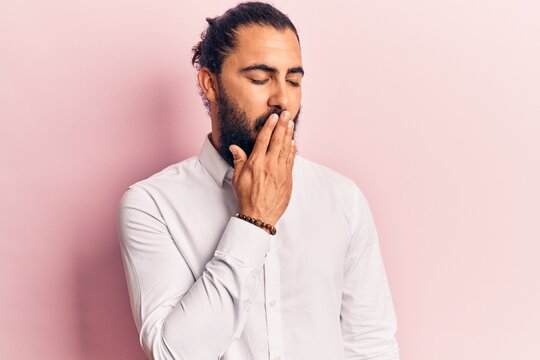 Young arab man wearing casual clothes bored yawning tired covering mouth with hand. restless and sleepiness.