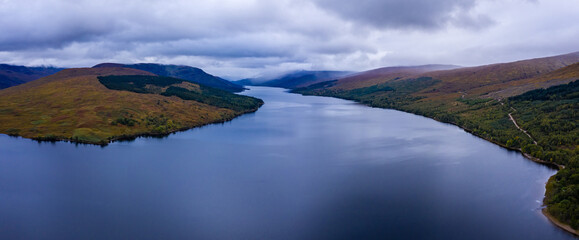 shot of loch arkaig in the argyll region of the highlands of scotland during autumn on a clear bright day showing calm waters on the inland loch