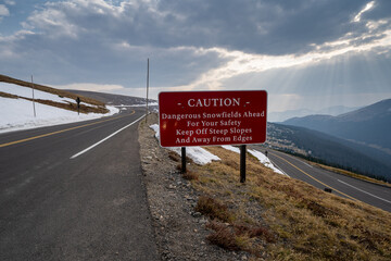 Caution - dangerous snowfields ahead sign, keep off steep slopes along Trail Ridge Road in Rocky...