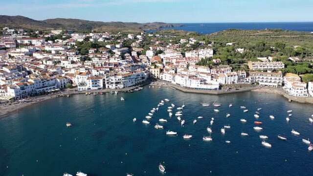 View from drone of small town Cadaques and many boats in bay, Costa Brava, Spain, famous tourist destination