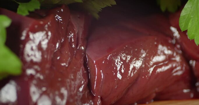 Raw liver with greens slowly rotates. 