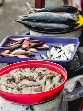 Jumbo Shrimp, Dalagang Bukid (Yellow Tail Fusilier), Tamban (Herring) And Frigate Tuna (Tulingan) For Sale At A Small Stall Outside A Philippine Market.