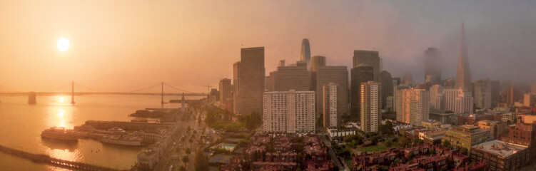 Fototapeta premium San Francisco Panorama with orange sky sunrise from nearby wildfire