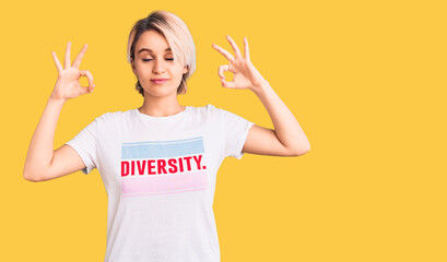 Young beautiful blonde woman wearing t shirt with diversity word message relax and smiling with eyes closed doing meditation gesture with fingers. yoga concept.