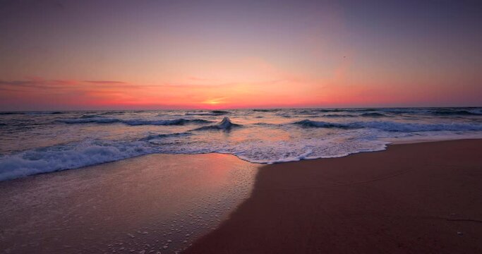 Ocean beach sunrise and dramatic colorful sky clouds