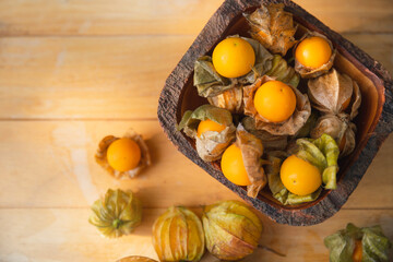 Gape gooseberries and natural background. Cape gooseberry on wooden table. Cape Gooseberry from top view.  fresh cape gooseberry background , selective focus .