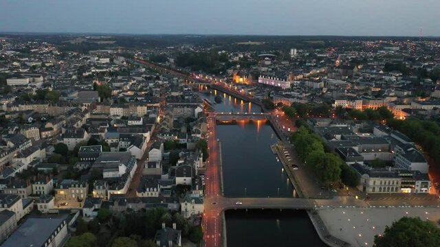 Evening aerial view of Laval with buildings, river Mayenne and old bridge, Mayenne department, north-western France. High quality 4k footage