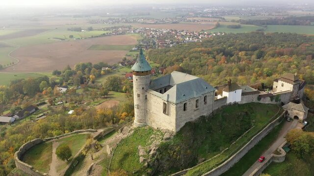 Picturesque autumn landscape with imposing historic Kuneticka Hora Castle on hilltop above Czech village of Raby, Pardubice Region