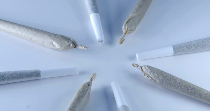 Rotating Cannabis Cigarettes, Prerolls or Joints on a grey background