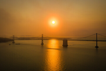 Fototapeta na wymiar Eerie orange sky over Bay Bridge in San Francisco