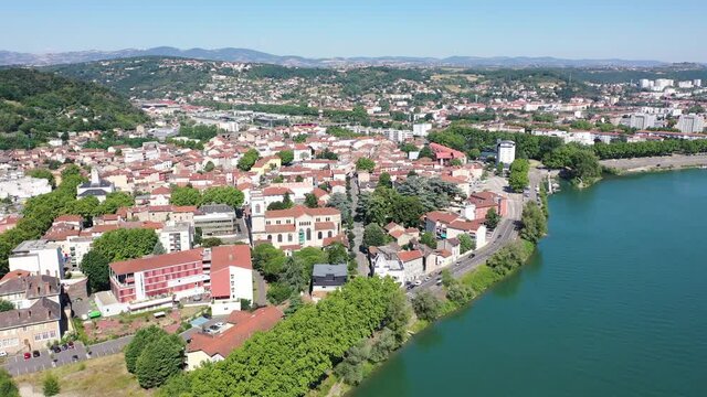 Picturesque view from drone of Givors summer cityscape on Rhone riverbanks, Auvergne-Rhone-Alpes region, France