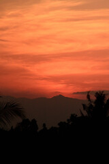 Beautiful sunset with the silhouette of coconut trees