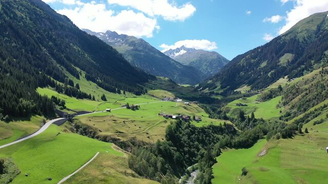 Scenic summer mountain landscape of Swiss Alps with green hillsides, valleys and highland pastures, canton of Grisons