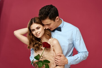 Lovers people with rose in hands on pink isolated background hug emotions happiness romance feelings