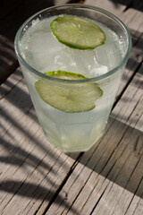 mojito cocktail on wooden table iced tea lemon tea water ice cubes in glass 
