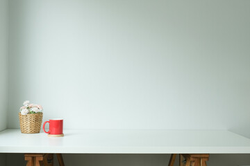 Minimal work desk with flower pot and coffee cup.
