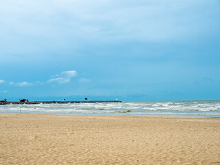 Seascape with sand beach under cloudy blue sky in Thailand