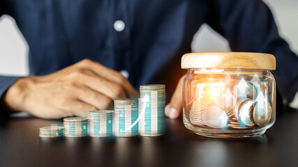 Businessman hand put coin stack,protect new business start-up,business development to success and growing growth concept