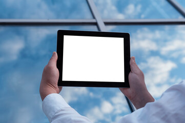 Mockup image of a Man holding black tablet in hand with blank white screen on background in the door.