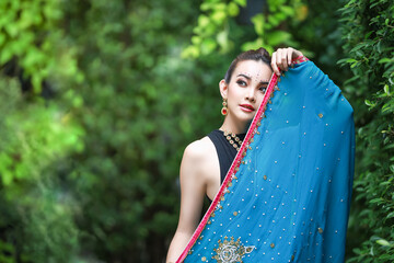 Portrait of beautiful young woman with black and blue traditional India costume.
