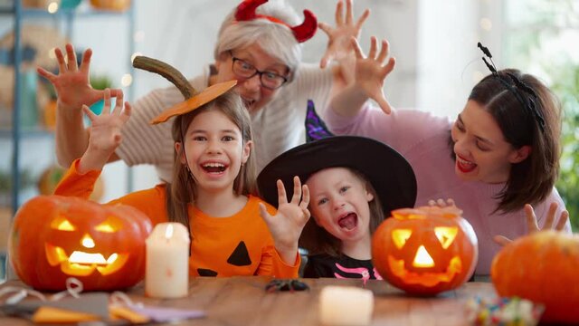 Happy family celebrating Halloween. Grandmother, mother and children at home. 
