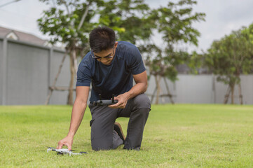 Drone pilot. Man using drone with remote controller.