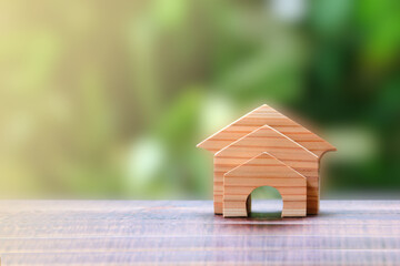 Obraz na płótnie Canvas small wood homes on wood floor with blur background , home loan concept