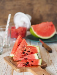 Ripe watermelons and slices in the background. Healthy natural food. Watermelon is a popular organic farming product.