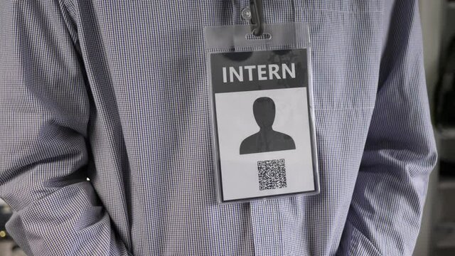 Intern wearing his ID badge around his neck to identify himself.