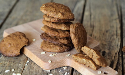Homemade oatmeal cookies with added whole grain rye flour on wooden background. Diet healthy food.