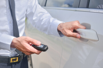 Close up hand holding key opening car door