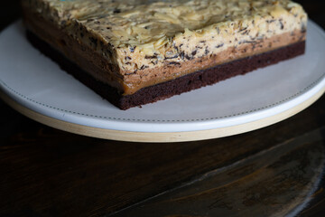 Overhead view of  white  chocolate cake on a white plate.