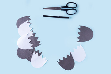 Halloween decorarion. Concept DIY and children creativity. Step-by-step instructions: make ghosts from white and black paper. Step 1 preparation paper and tools for handmade craft. Copy space for text