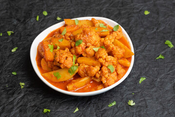 Aloo Gobi Indian curry dish with potatoes and cauliflower. sabzi- potatoes with cauliflower, Indian style vegetable curry. Traditional North Indian vegetarian curry dish