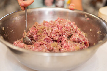 making hamburgers in kitchen with ground beef