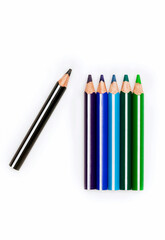 Naklejka premium colored pencils row on white background