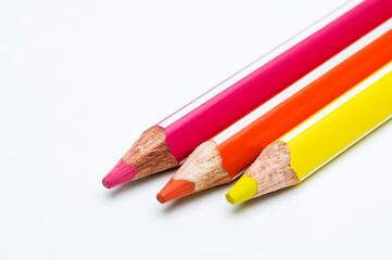colored pencils row on white background