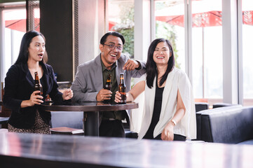 Happy business party celebration with drinking beer and champaing for work success at pub bar restaurant