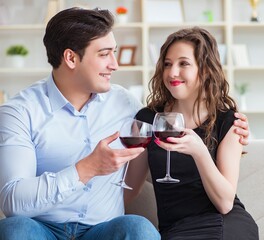 Young pair drinking wine in romantic concept