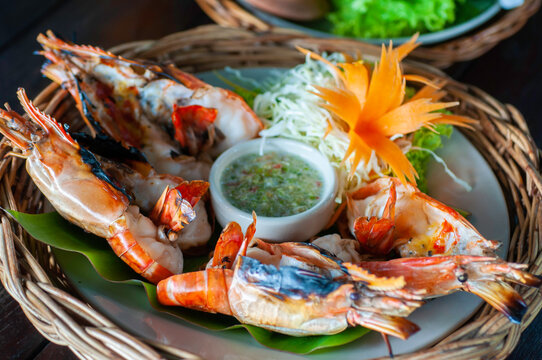 Grilled shrimp in wicker basket serve with spicky seafood sauce, Fresh shrimp roasted in Thailand.