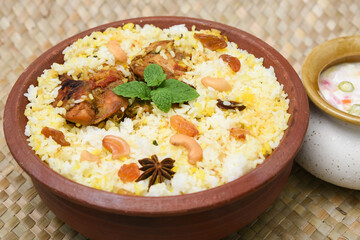 Chicken biryani. Spicy Indian Malabar biryani or Hydrabadi biryani, Dum Biriyani,  fish and rice. pulao basmati rice, spicy mixed rice dish with meat curry for Ramadan Kareem, Eid