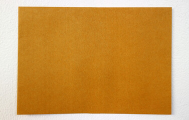 Yellow paper on white wall