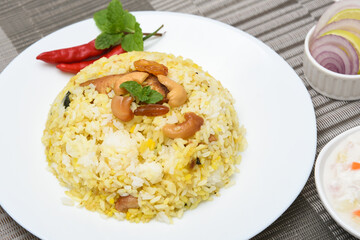 Chicken biryani. Spicy Indian Malabar biryani or Hydrabadi biryani, Dum Biriyani,  fish and rice. pulao basmati rice, spicy mixed rice dish with meat curry for Ramadan Kareem, Eid