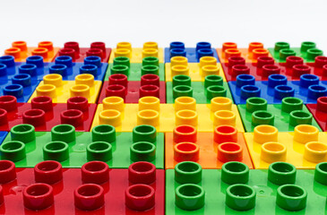 Colored plastic building blocks isolated on white background