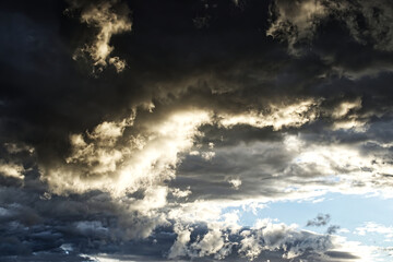 Dramatic sky with stormy clouds at sunset. Natural photo background
