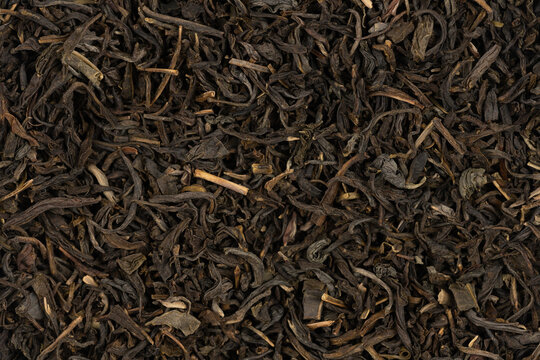 Dried tea leaves background texture. close-up
