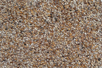 Brown graveled wall. Mixed mineral and rock texture